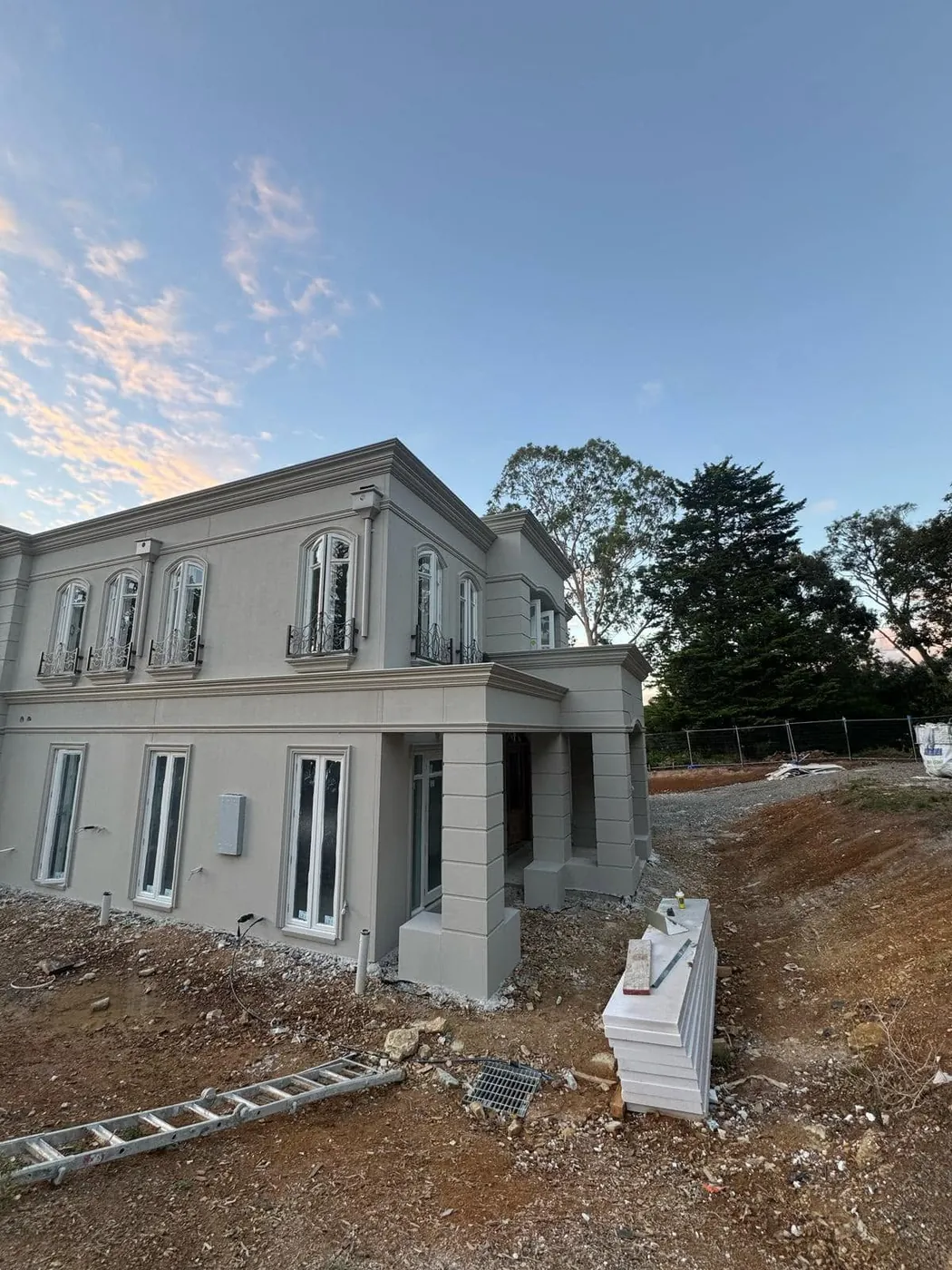 Rows of arched windows with mouldings along the side of a French provincial home
