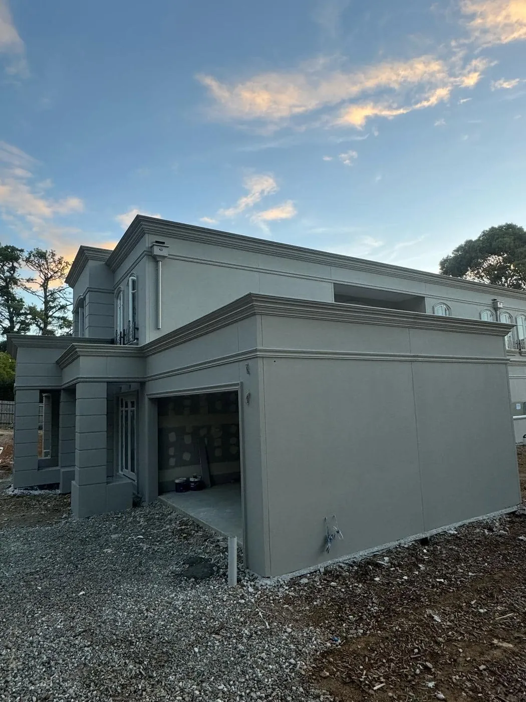 Side and garage elevation with crisp square-set render bands