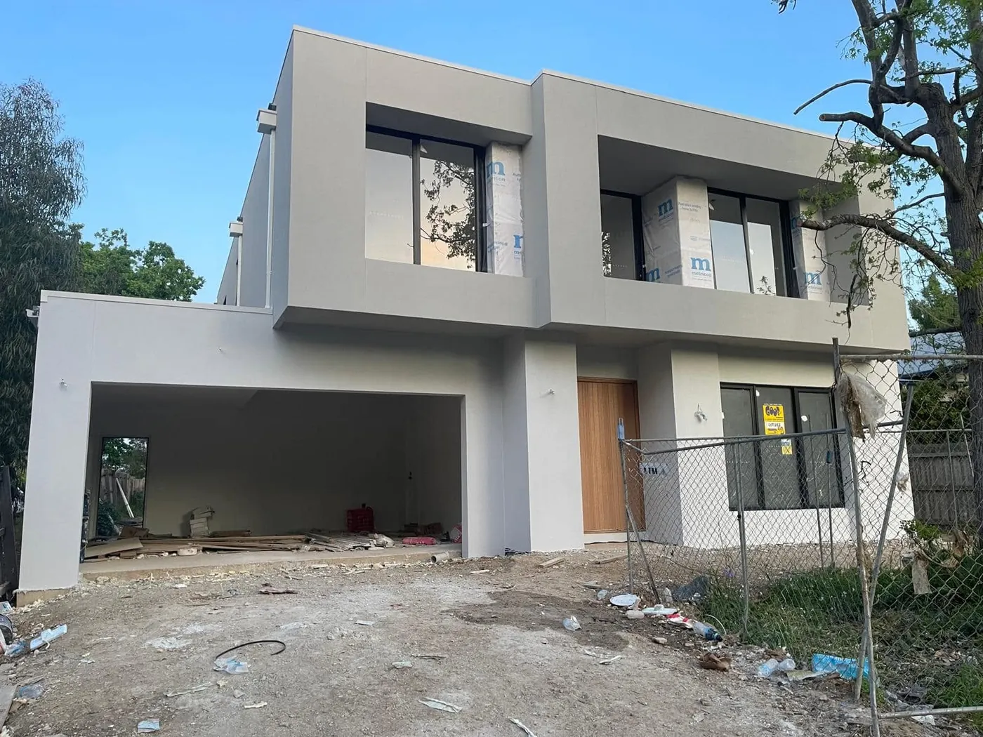 Finished modern double-storey in Mont Albert with smooth off-white render and timber front door