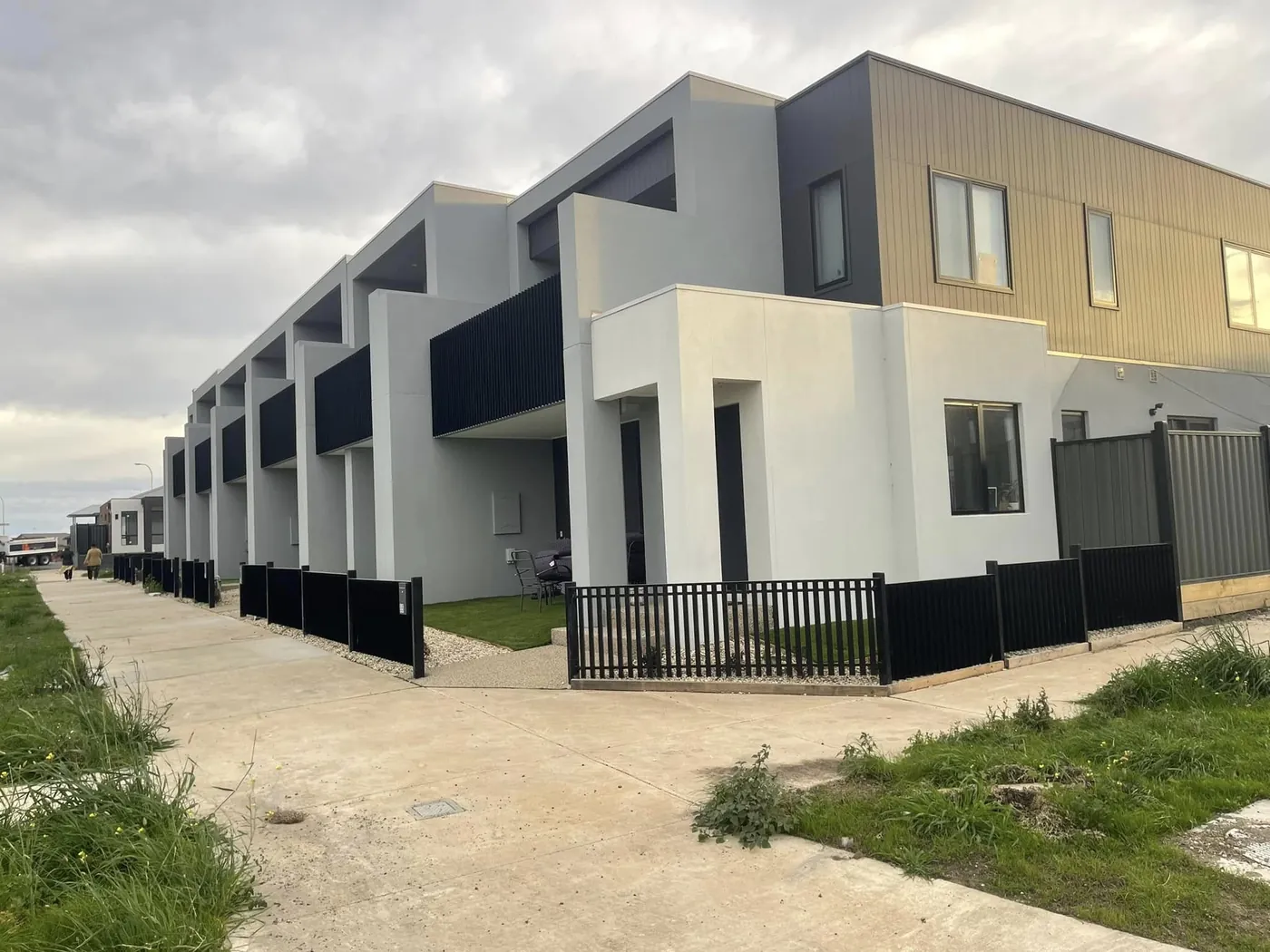 Donnybrook townhouses with white render ground floor and charcoal cladding above