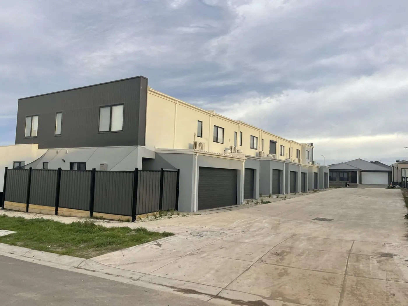 Long run of rendered garages and facades at the Donnybrook townhouse development