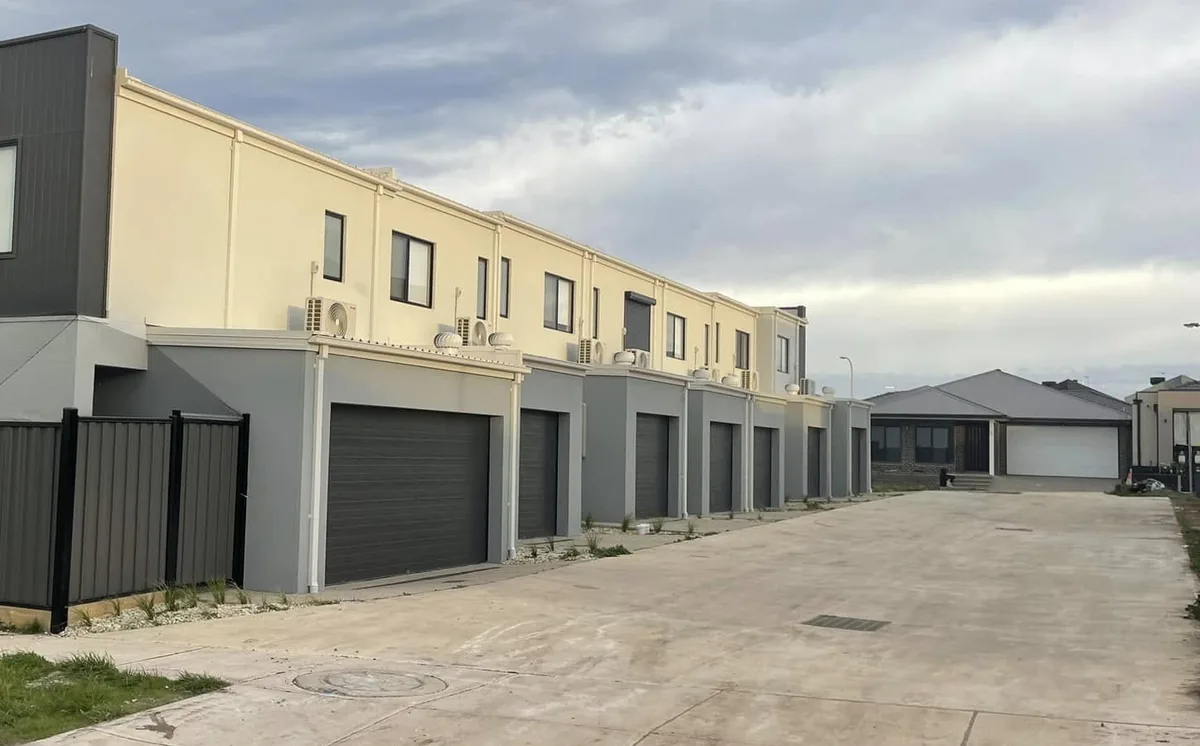 Row of rendered townhouse garages and facades